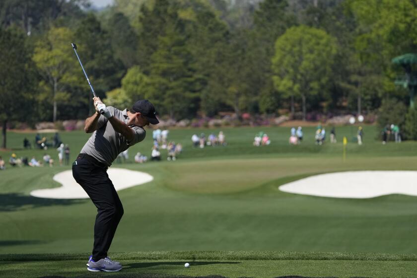 Rory McIlroy, of Northern Ireland, tees off on the fourth hole during a practice round for the Masters golf tournament.