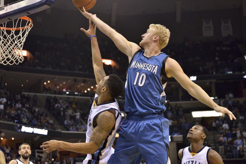 FILE - Minnesota Timberwolves forward Chase Budinger (10) shoots over Memphis Grizzlies guard Courtney Lee during the second half of an NBA basketball game Oct. 29, 2014, in Memphis, Tenn. Former NBA player Budinger is going to the Olympics — for beach volleyball. The 6-foot-7 Californian, who helped Arizona reach the Sweet 16 in 2009 before playing seven seasons with the Rockets, Timberwolves, Pacers and Suns, earned a berth with Miles Evans as the No. 2 U.S. men’s pair at the FIVB tournament Wednesday, June 5, 2024, in Ostrava, Czechia. (AP Photo/Brandon Dill, File)
