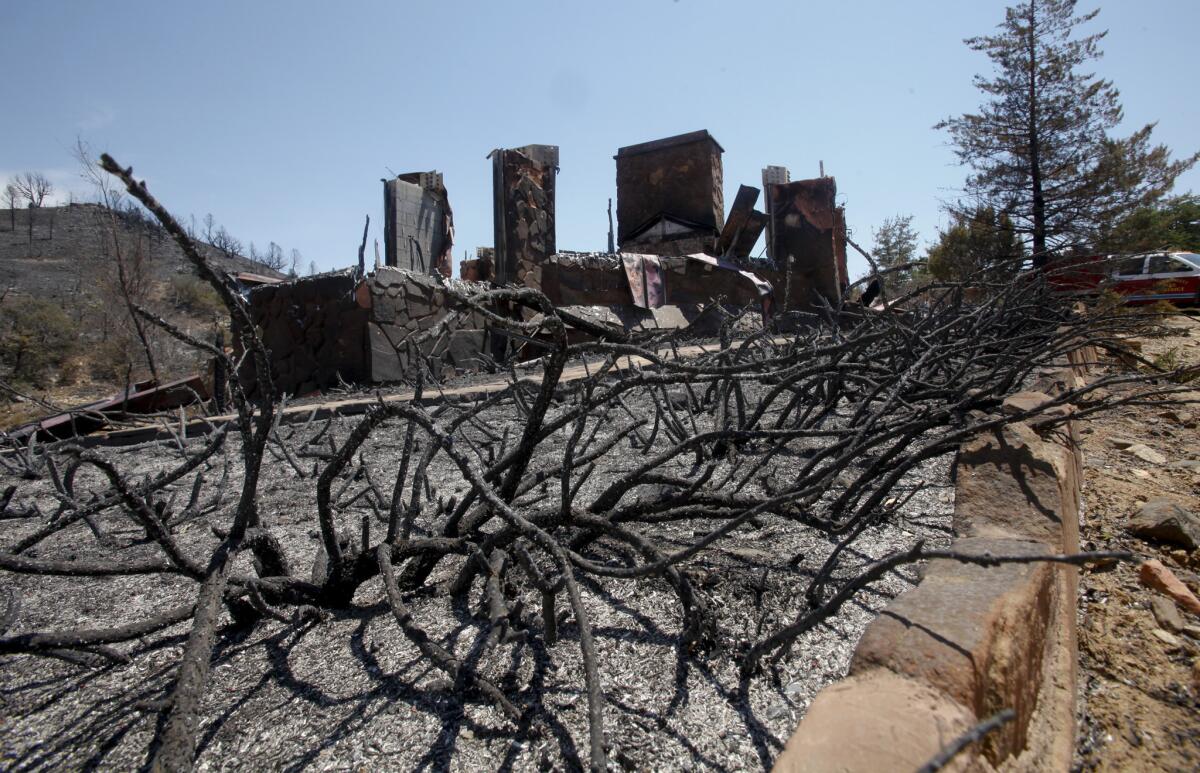 More than 100 dwellings, including this one the Peeples Valley area, were destroyed in the Yarnell Hill fire in Arizona last summer. The wildfire killed 19 members of the Granite Mountain Interagency Hotshot Crew.