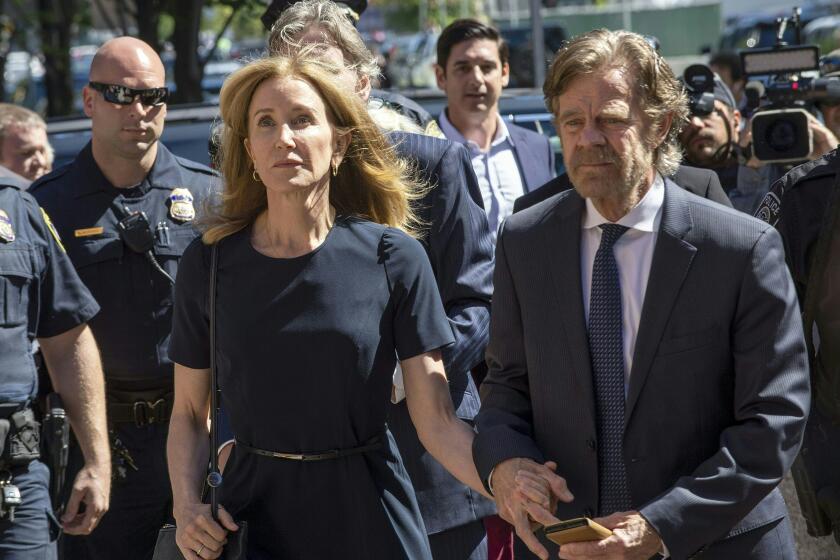 Actress Felicity Huffman, escorted by her husband William H. Macy, makes her way to the entrance of the John Joseph Moakley United States Courthouse September 13, 2019 in Boston, where she will be sentenced for her role in the College Admissions scandal. - Huffman, one of the defendants charged in the college admissions cheating scandal, is scheduled to be sentenced for paying $15,000 to inflate her daughters SAT scores, a crime she said she committed trying to be a good parent. (Photo by Joseph Prezioso / AFP) (Photo credit should read JOSEPH PREZIOSO/AFP/Getty Images)