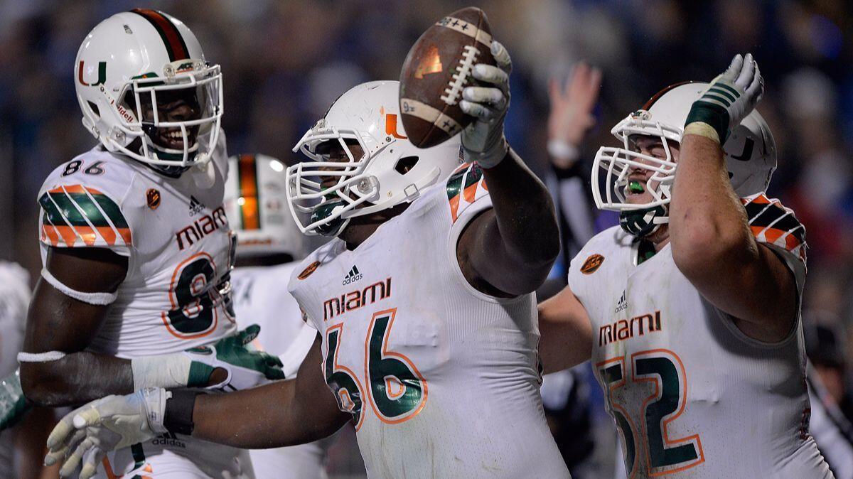 Sunny Odogwu (66) celebrates with teammates after recovering a fumble in the end zone for a Miami Hurricanes touchdown during their game against the Duke Blue Devils on Oct. 31, 2015. (Grant Halverson / Getty Images)