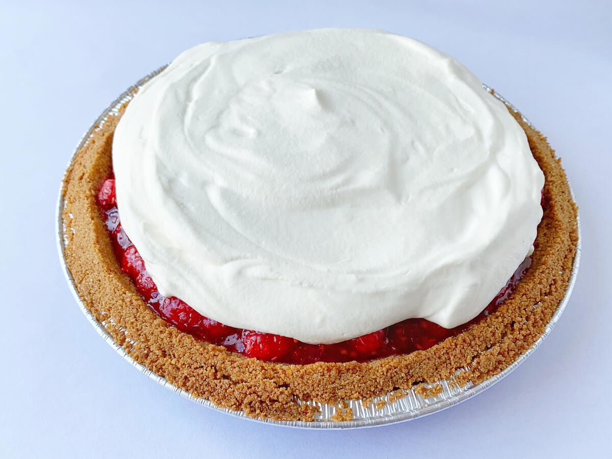 A thick layer of whipped cream is all you need to balance a tart, fresh raspberry filling and snappy graham cracker crust.