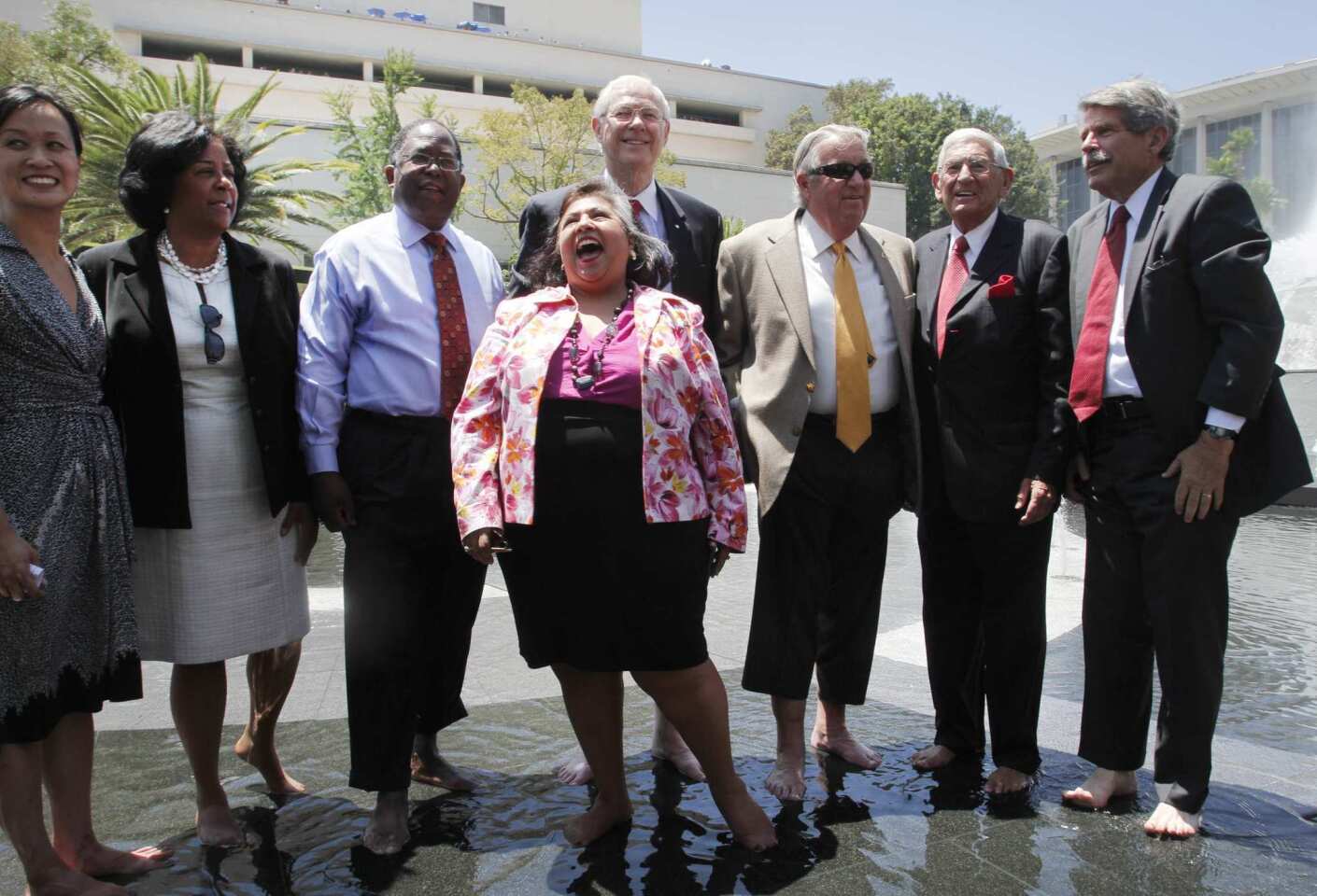Los Angeles politicians and billionaire philanthropist Eli Broad took off their dress shoes and celebrated together in the renovated Arthur J. Will Memorial Fountain on Thursday to cap off the opening of Grand Park. From left are Bea Hsu, vice president, development, Related California (Related Cos. funded the new park); Councilwoman Jan Perry, Los Angeles County Supervisor Mark Ridley-Thomas, Supervisor Gloria Molina, Supervisor Michael D. Antonovich, Supervisor Don Knabe, Broad and Supervisor Zev Yaroslavsky.