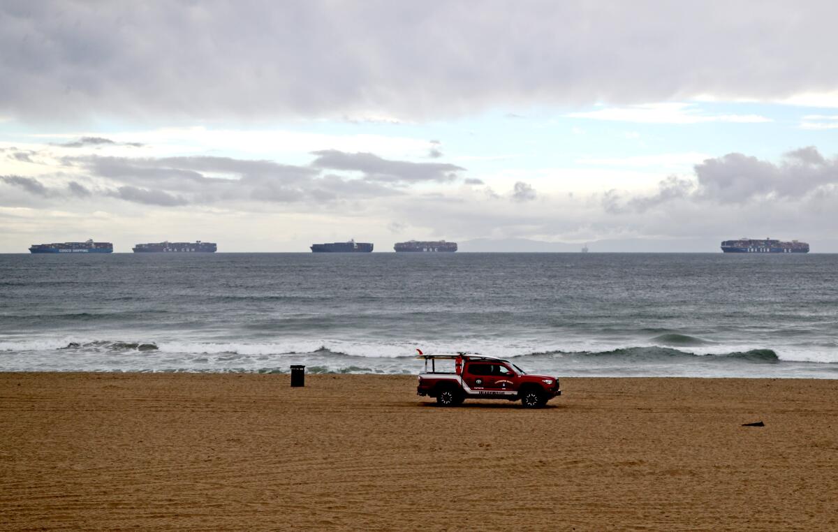 Cargo ships can be seen anchored off the coast of Huntington Beach. 