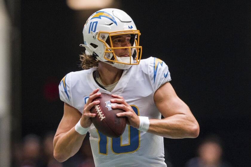 Los Angeles Chargers quarterback Justin Herbert (10) works during the first half of an NFL football game.