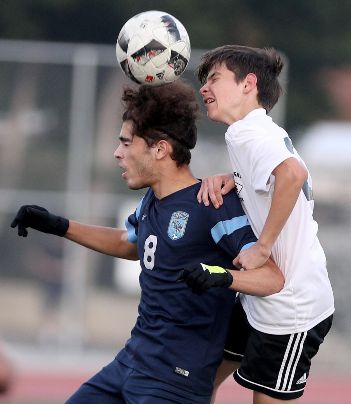 Crescenta Valley High player Argin Baharians, left, heads the ball as Burroughs Zac Levy goes up as well in game at Crescenta Valley High in La Crescenta on Friday, Dec. 13, 2019.