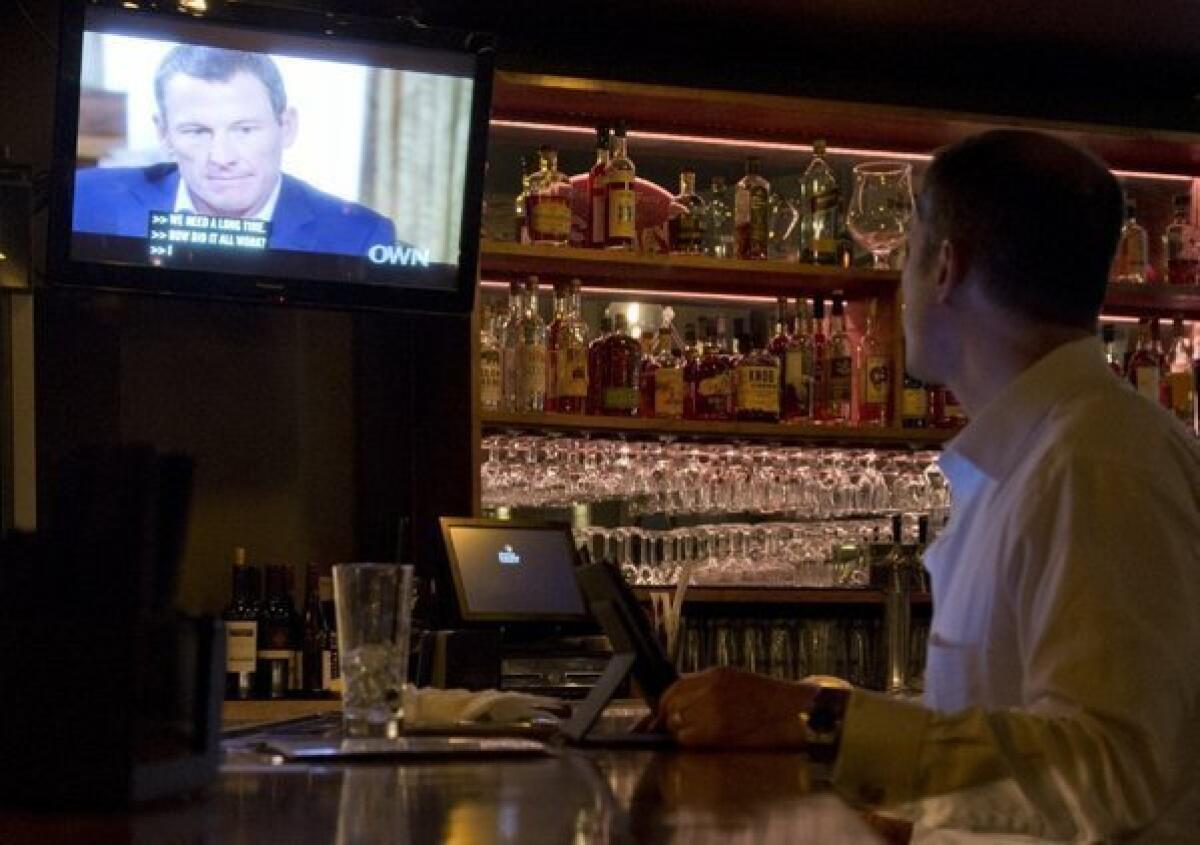 A man watches Lance Armstrong's interview with Oprah Winfrey at a downtown Los Angeles bar on Thursday.