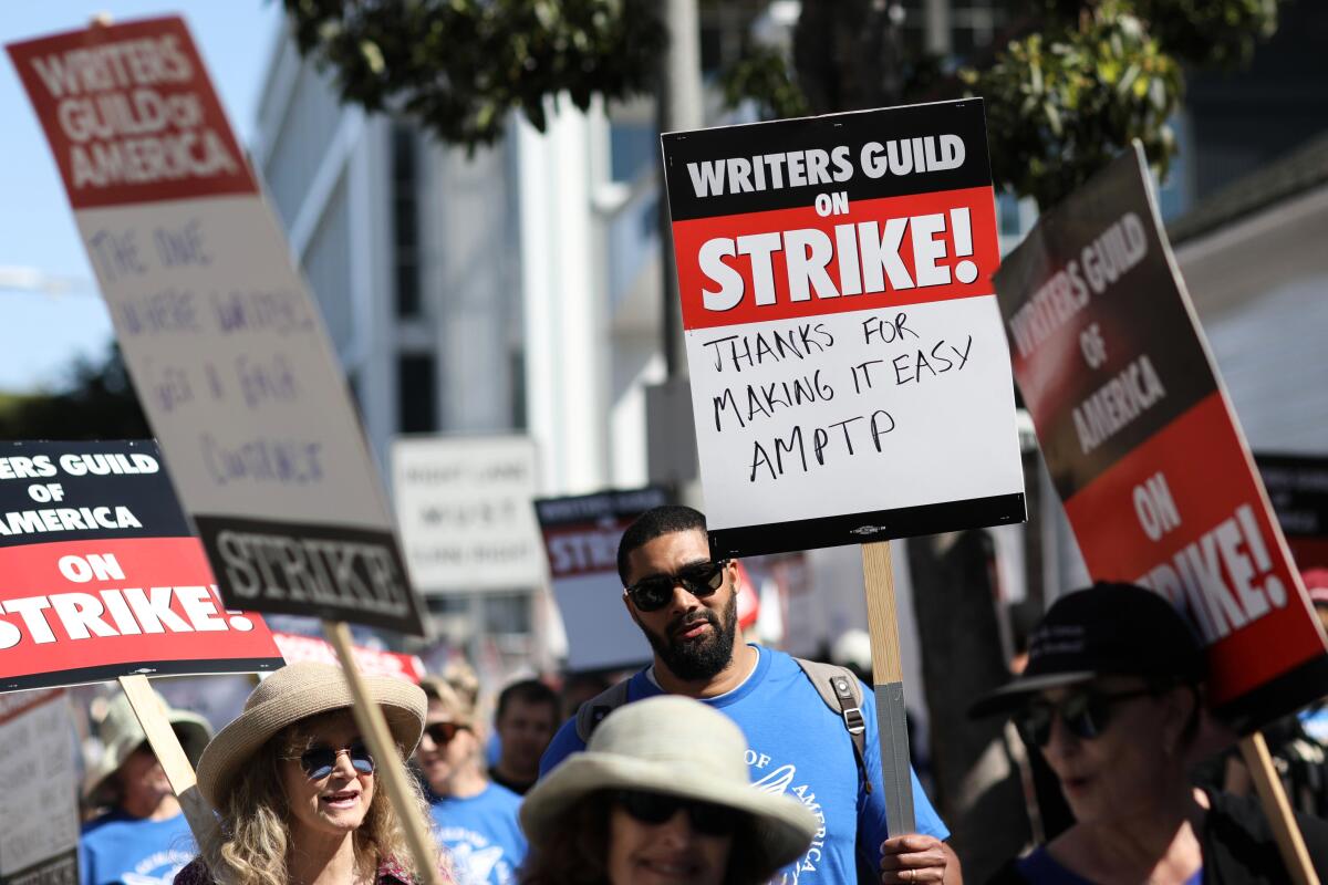 Writers Guild of America members walk the picket line in front of Amazon studios.