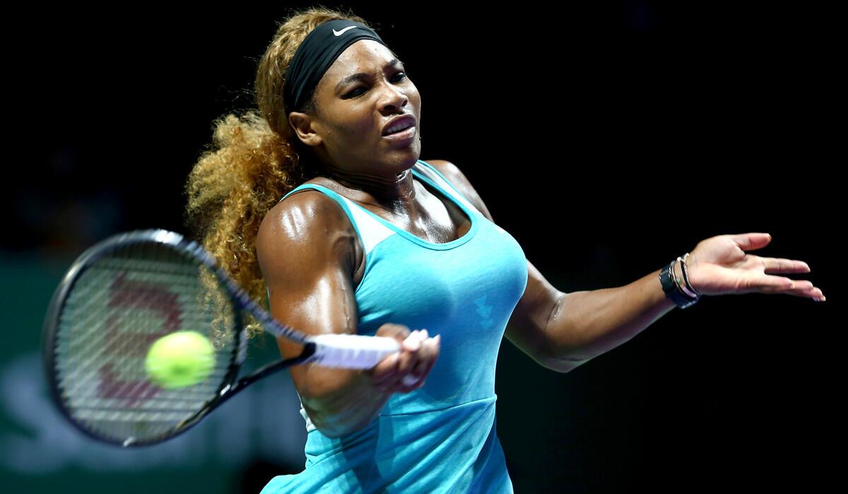 Serena Williams plays a forehand against Caroline Wozniacki in a semifinal match at the WTA Finals in Singapore on Saturday.