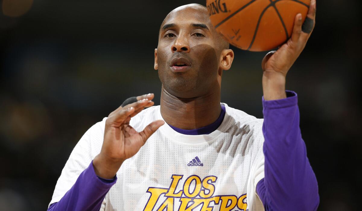 Lakers forward Kobe Bryant warms up before facing the Denver Nuggets on Wednesday.