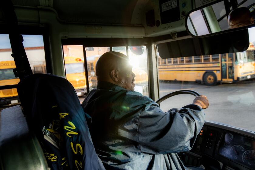 GARDENA, CA - MARCH 17, 2023: School bus driver John Lewis pulls into the Gardena bus yard at the end of the day on March 17, 2023 in Gardena, California. Lewis will be affected when LAUSD's essential workers go on strike and shut down schools. (Gina Ferazzi / Los Angeles Times)