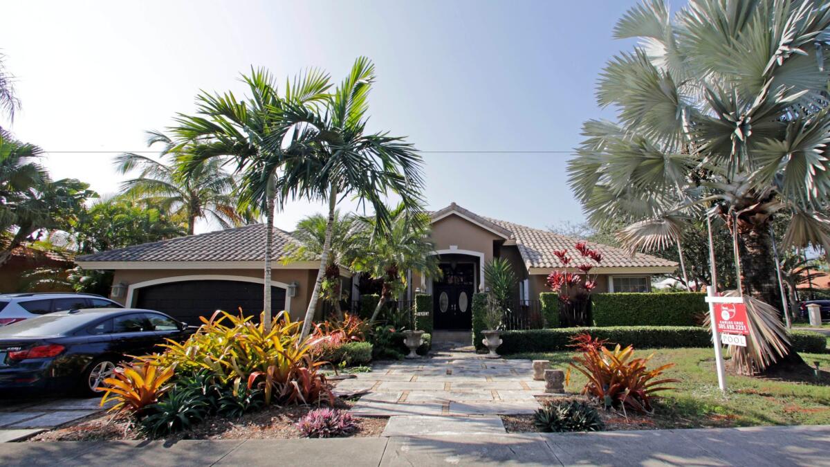 Home sales and prices have been helped by healthy demand, tight supplies and low mortgage rates. Above, a house for sale in Miami.