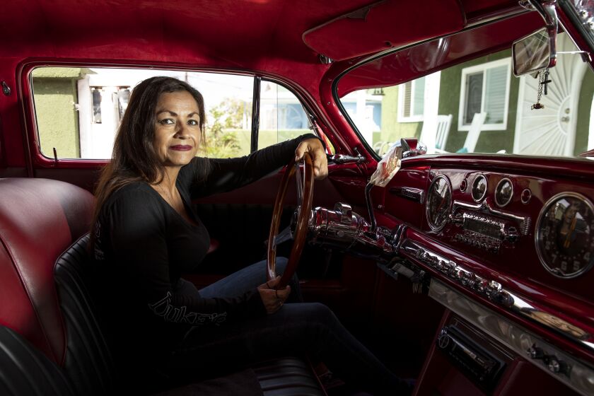 National City, CA - August 20: Marisa Rosales, founding member of the United Lowrider Coalition, poses for a photo inside of her 1949 Hudson Brougham on Friday, Aug. 20, 2021 in San Diego, CA. Rosales became the owner of Christine after her boyfriend died in 1999. "I held on to her, in a way to keep me connected to him," Rosales said. That's why I built her in his memory, to make him proud, to fulfill his dream… then in doing that it tied me into a whole culture." National City enacted a no cruising ordinance in 1992 after there was a report in crime and traffic congestion. The United Lowrider Coalition banded together earlier in the year with a goal to have the no cruising ordinance repealed and lowriders can once again drive down Highland Avenue. A forum is set for Sept. 9 to discuss the issue. (Ana Ramirez / The San Diego Union-Tribune)