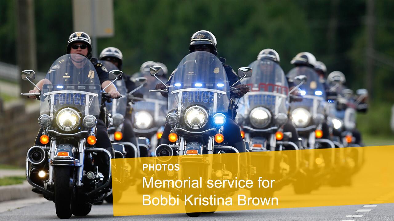 A police motorcycle procession escorts guests to the memorial service Aug 1, 2015, for Bobbi Kristina Brown at St. James United Methodist Church in Alpharetta, Ga.