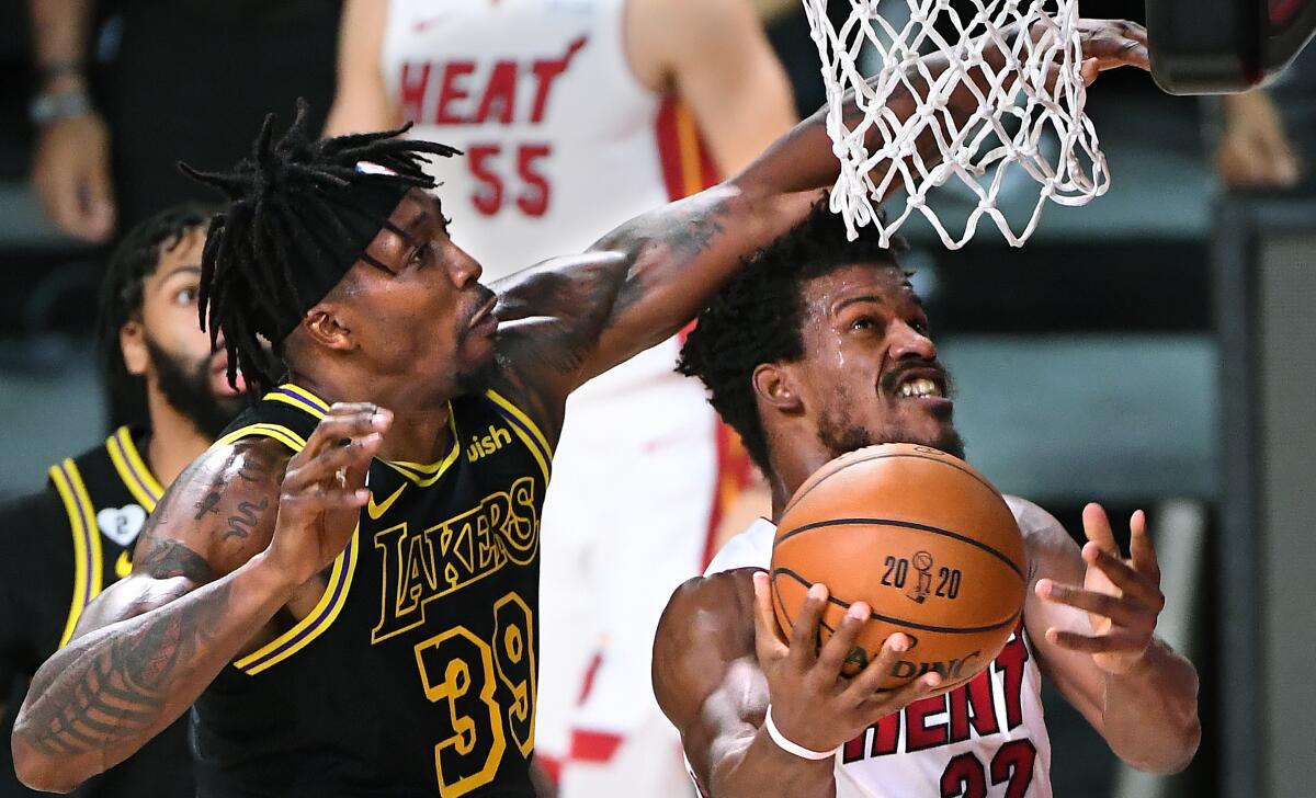 Lakers center Dwight Howard fouls Heat forward Jimmy Butler during a drive in Game 5.