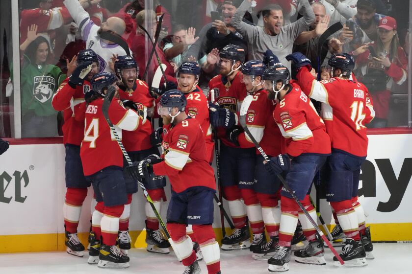 The Florida Panthers team celebrate after center Carter Verhaeghe (23), third from left, scored the game winning goal during overtime in Game 3 of the NHL hockey Stanley Cup Finals, Thursday, June 8, 2023, in Sunrise, Fla. The Florida Panthers defeated the Vegas Golden Knights 3-2. (AP Photo/Rebecca Blackwell)