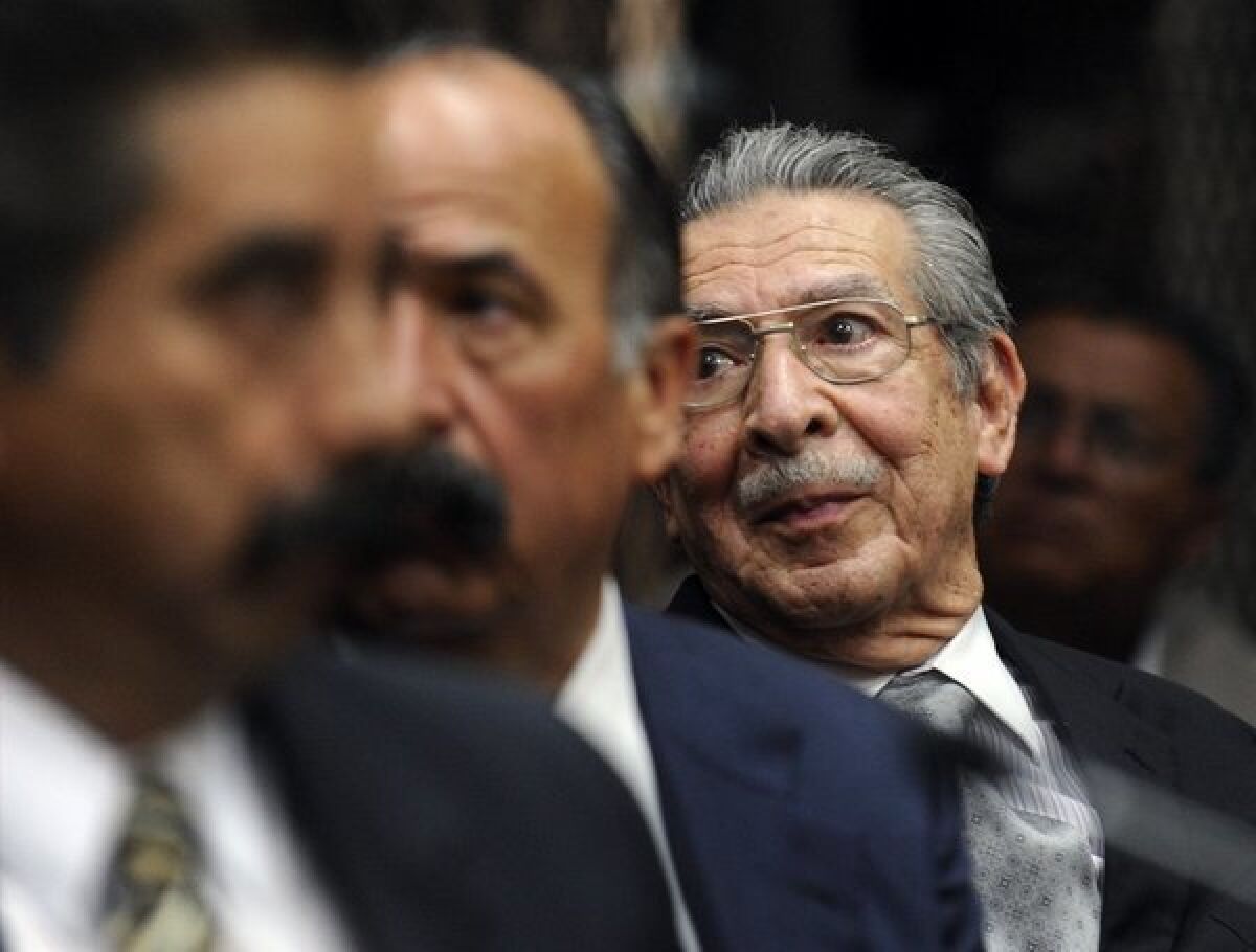 Former Guatemalan leader Efrain Rios Montt, in glasses, appears at a court hearing in Guatemala City. A judge ordered that Rios Montt, 86, face trial on genocide charges.