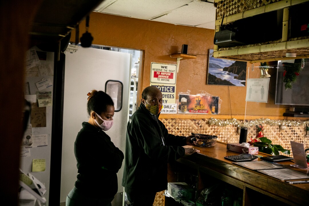 Owner Shimeles Kibret works behind the counter with his wife Yetanyet 
