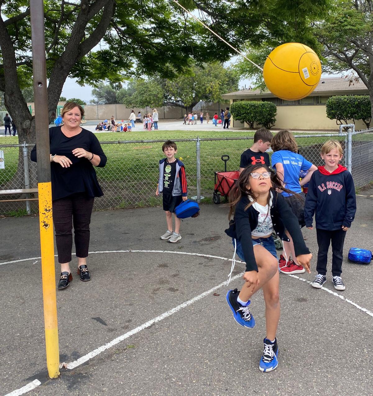Principal Elizabeth Ward enjoying an enthusiastic game of lunch time tetherball with Sessions student Lily Martinez.