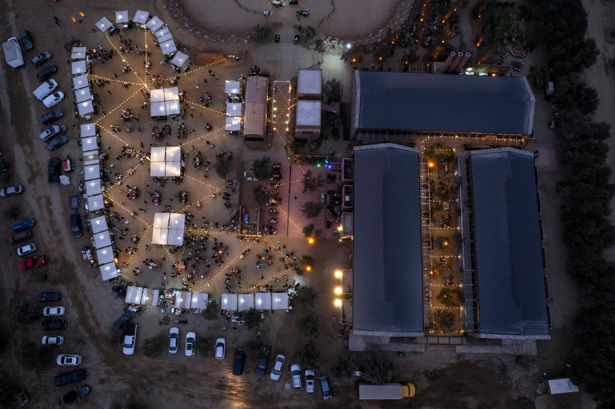 Aerial view of the Valle Food & Wine Festival at the Bruma winery, with rows of booths and large warehouses