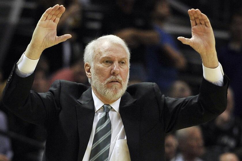 San Antonio Spurs Coach Gregg Popovich signals to his players during a 125-118 win over the Clippers on Dec. 22, 2014.