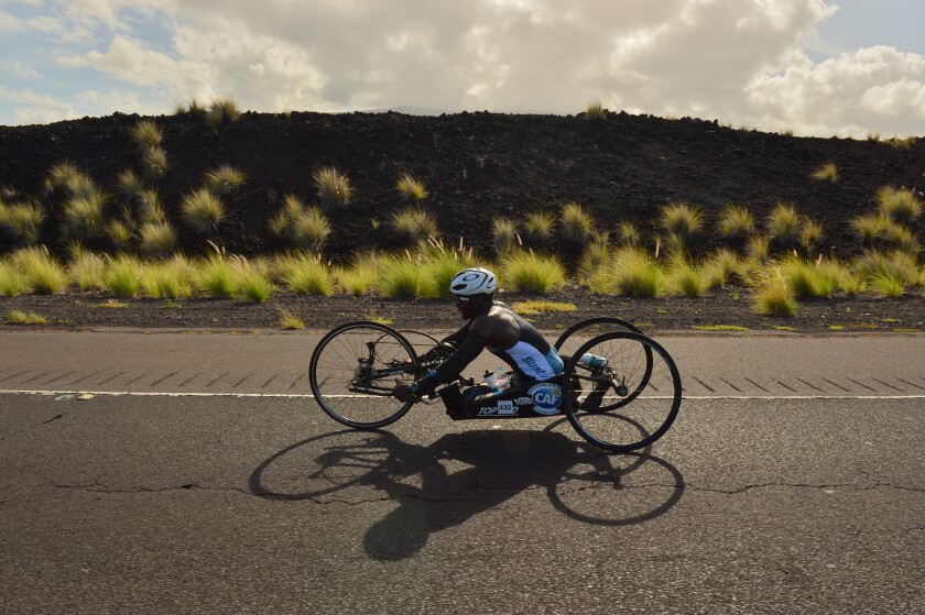 Roderick Sewell, 27, uses a kneeler-style handcycle to complete the 112-mile biking portion of the Ironman World Championship in Kailua-Kona , Hawaii, on Oct. 12.