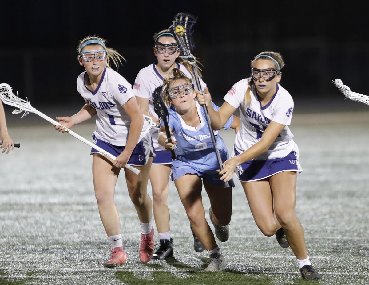 Newport Harbor's Sophia LeClaire, far right, moves the ball during Battle of the Bay girls' lacrosse against CdM on Thursday.