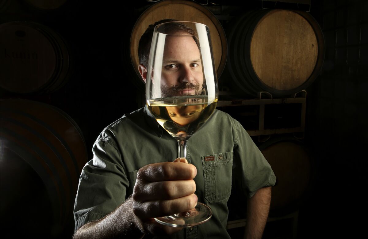 Winemaker Graham Tatomer holds a glass of Riesling, a very good thing to drink during hot weather.