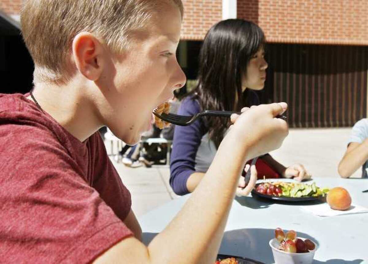 Ian Dankowski, 12, takes a bite of pasta during lunchtime at Rosemont Middle School in La Crescenta on Thursday, October 4, 2012. Federal guidelines for school lunches mandates a healthier menu, including whole grain pastas, low fat cheese, and every student must take one-half cup of fruit or vegetables per day.