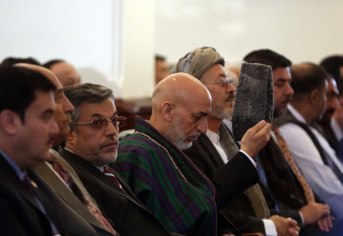 Outgoing Afghan President Hamid Karzai, center, attends his farewell ceremony at the presidential palace in Kabul, Afghanistan, on Tuesday.