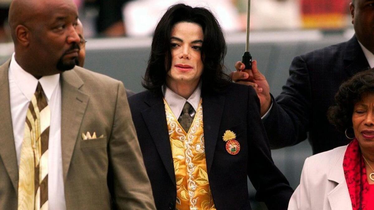 In this May 25, 2005, photo, Michael Jackson arrives at the Santa Barbara County Courthouse for his child molestation trial in Santa Maria, Calif. A documentary film about two boys who accused Michael Jackson of sexual abuse is set to premiere at the Sundance Film Festival.