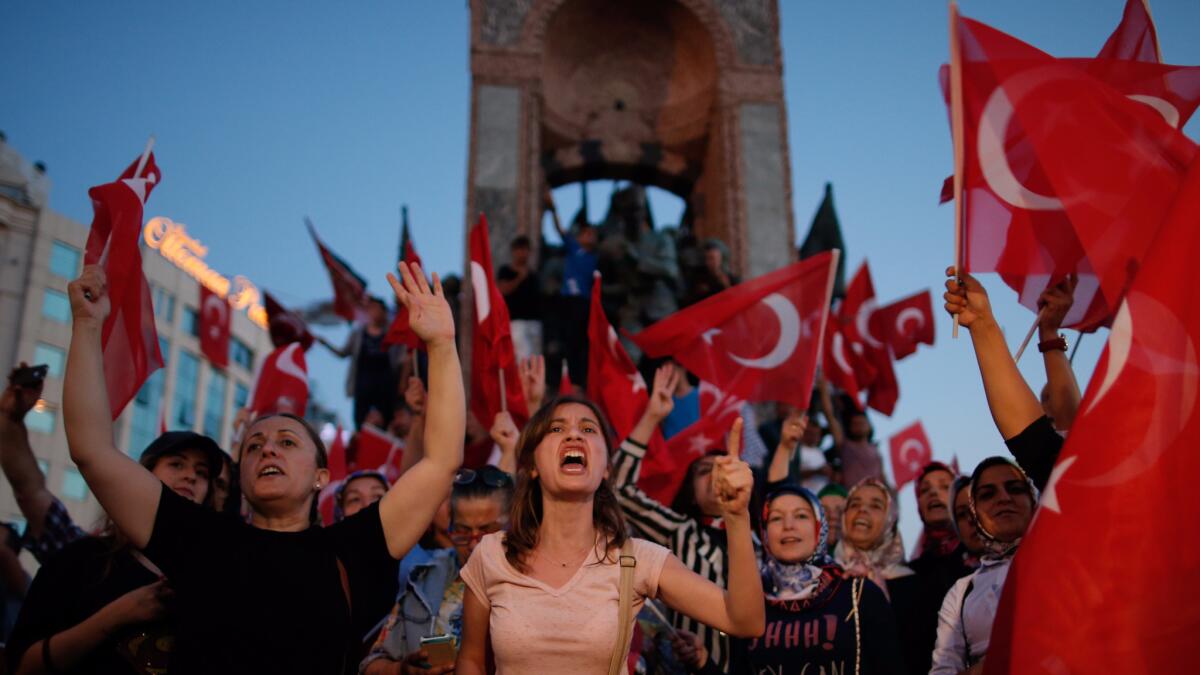 People chant slogans as they gather at a pro-government rally in central Istanbul's Taksim square, Turkey in July.