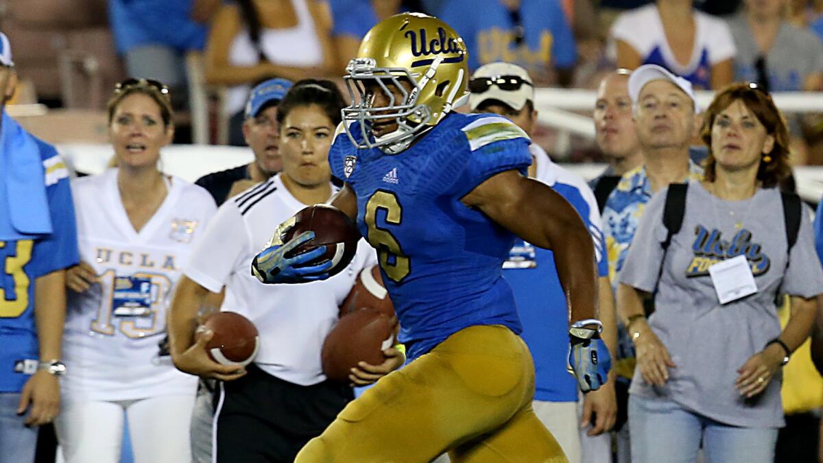 UCLA running back Jordon James scores on a 26-yard run against Nevada last season.