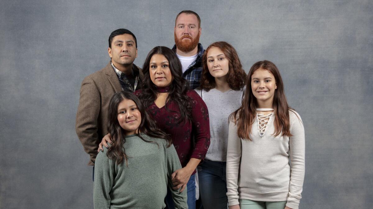 Director Rudy Valdez, left, with the Shank family, including Cindy Shank, in red, with her daughters Annalis Shank, left, Autumn Shank, Ava Shank and her ex-husband Adam Shank.