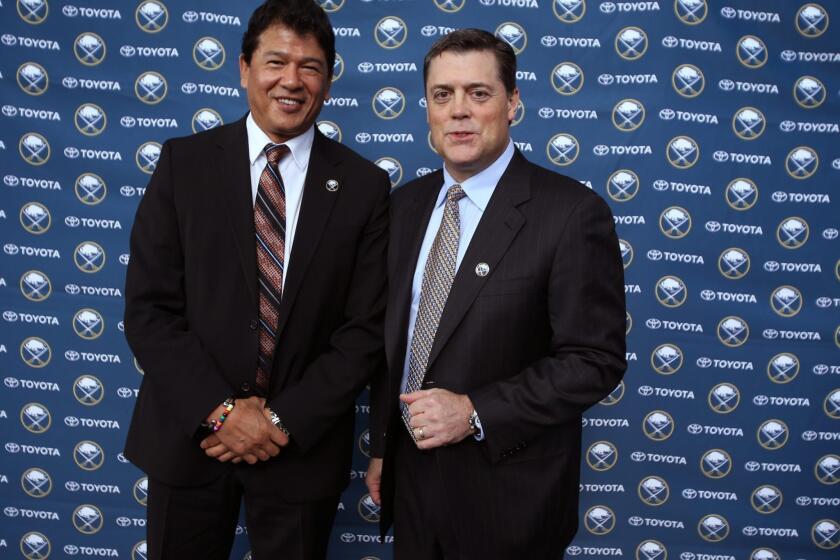 New Buffalo Coach Ted Nolan and president of hockey operations Pat LaFontaine pose for photos at a news conference Wednesday.