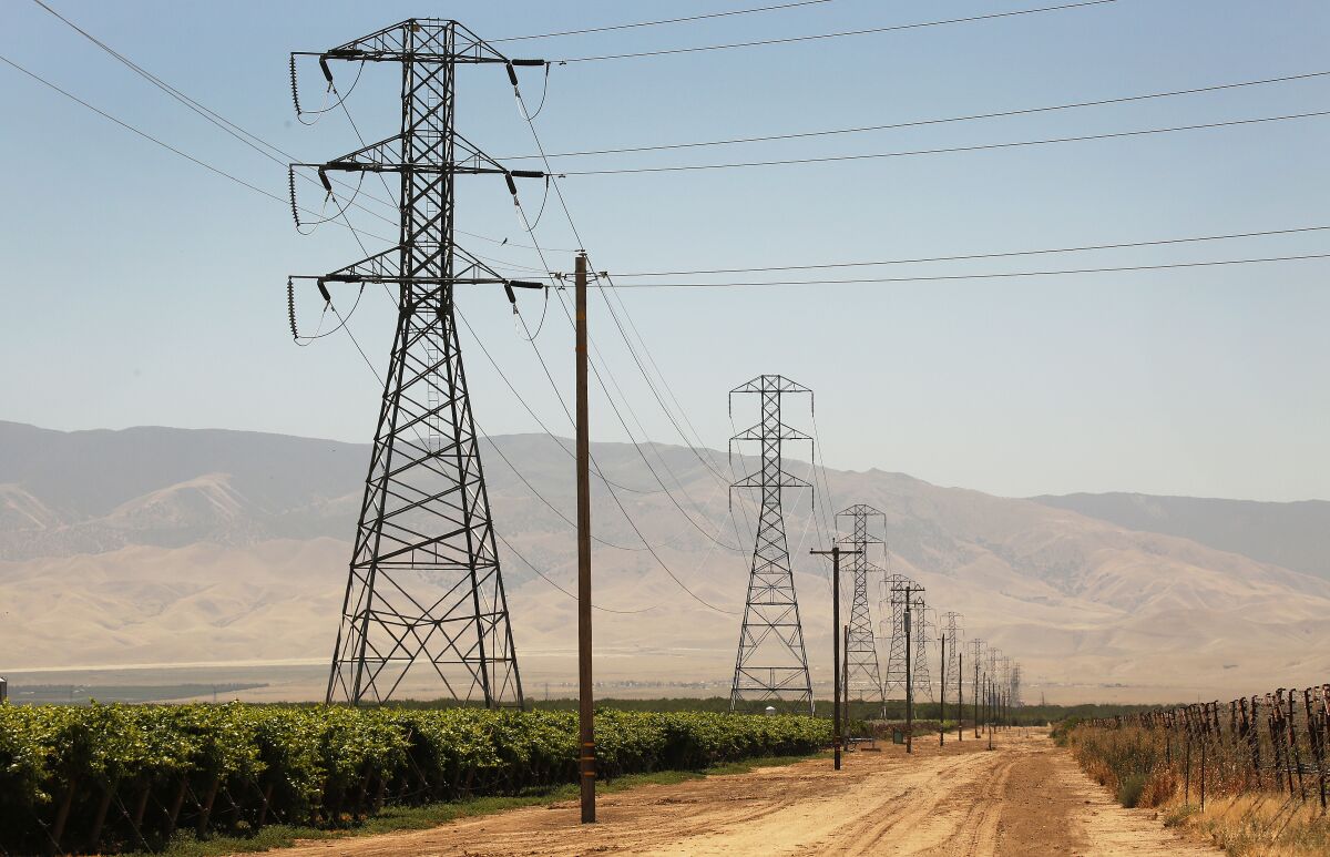 Power lines run through farmland in Kern County