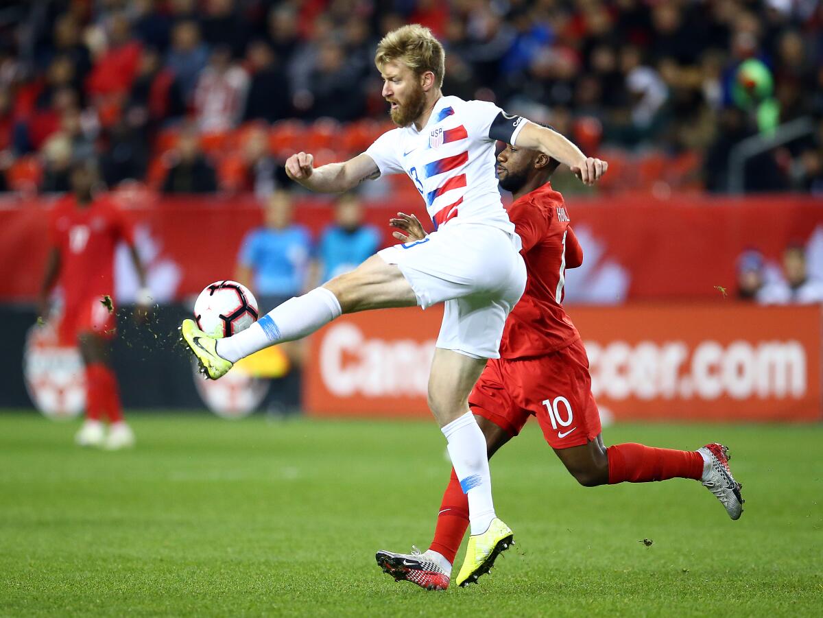 U.S. defender Tim Ream clears the ball from Canada's David Junior Hoilett during their Nations League game on Oct. 15, 2019, in Toronto.
