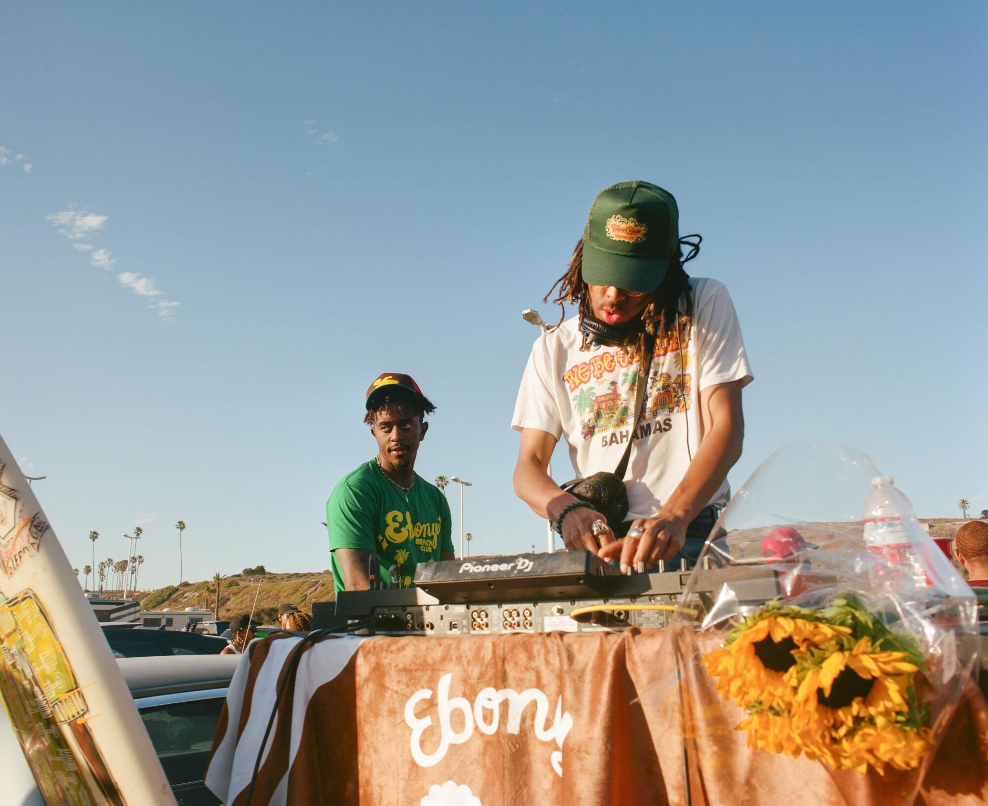 A man DJs at a beach