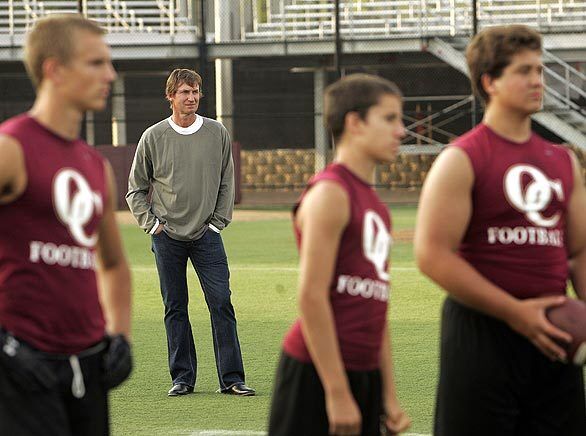 Hockey Hall of Famer Wayne Gretzky watches as members of the Oaks Christian High School football team take part in a passing tournament at the Westlake Village campus. Gretzky's son Trevor, 15, is a quarterback on the junior varsity team. Also on the squad: Nick Montana, the son of NFL great Joe Montana, and Trey Smith, the son of box-office champ Will Smith. Montana is competing for the varsity quarterback spot.