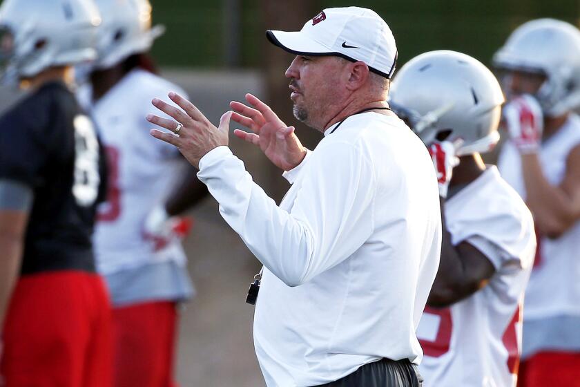 Coach Tony Sanchez makes a point during a UNLV training session on Aug. 20.