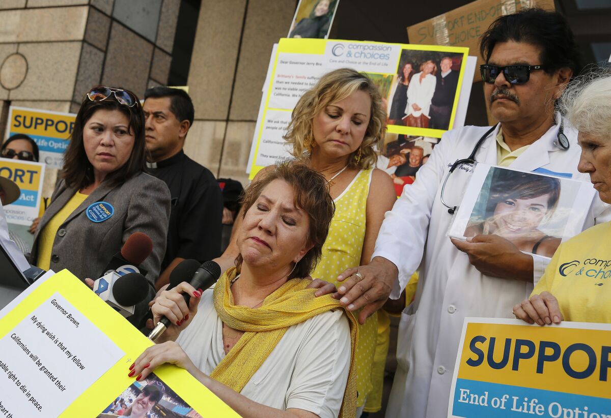 Former Los Angeles Police Officer Christy O'Donnell, who has since died of a terminal illness, is pictured center with scarf at a September rally for the End of Life Option Act, which will take effect June 9.