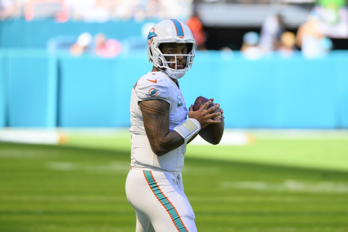 Miami Dolphins quarterback Tua Tagovailoa throws the ball as he warms up.