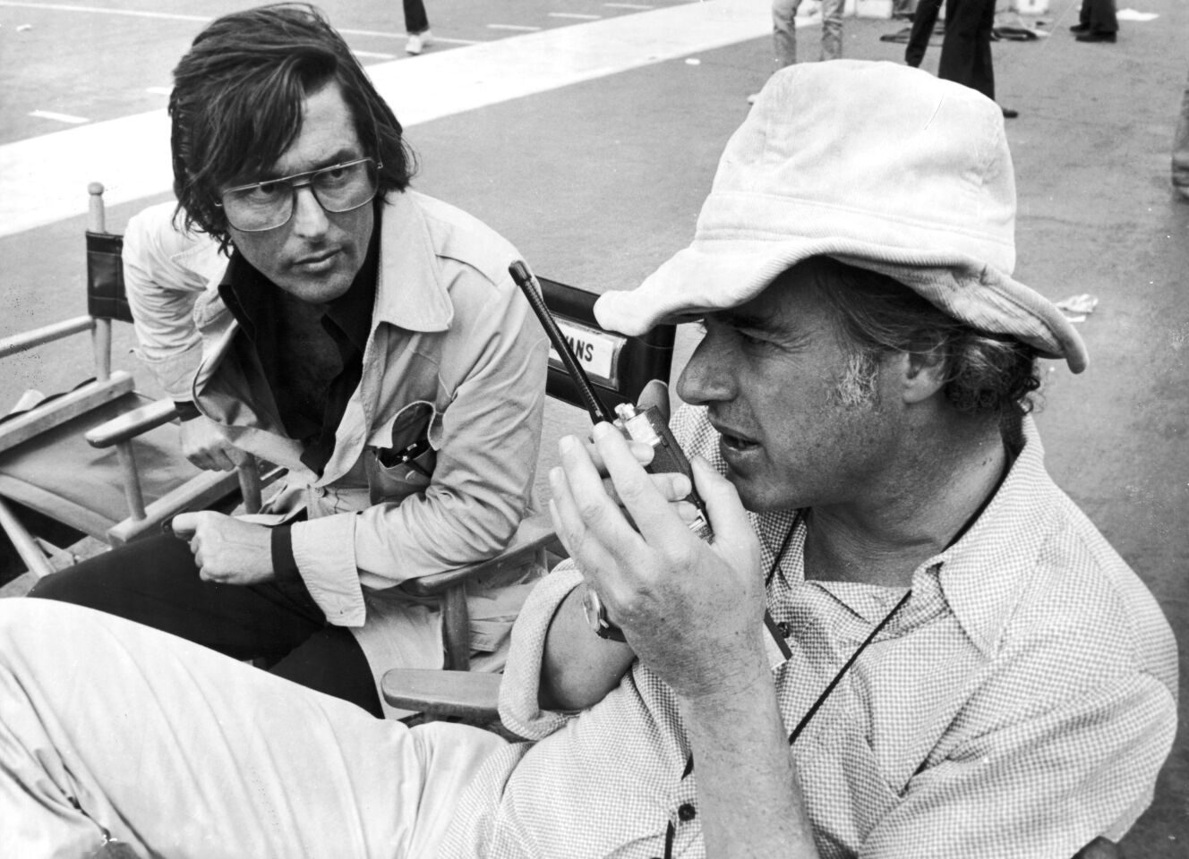 Robert Evans, left, works with director John Frankenheimer on the set of the film "Black Sunday" in 1976.