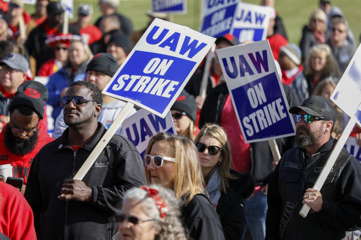 United Auto Workers union members and their families rally