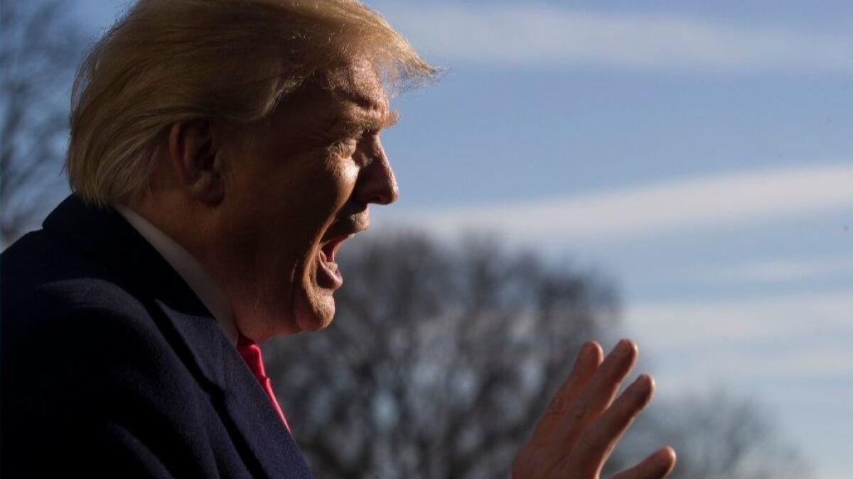 President Trump speaks to reporters at the White House on Sunday as he returned from a trip to Camp David to meet with aides.