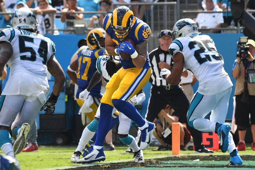 CHARLOTTE, NORTH CAROLINA SEPTEMBER 8, 2019-Rams tight end Tyler Higbee catches a touchdown pass in front of Panther defenders Shaq Thompson, left, and Eric Reid at Bank in the 4th quarter of America Stadium in Charlotte Sunday.(Wally Skalij/Los Angeles Times)