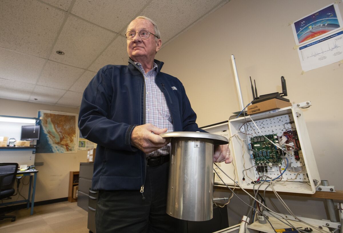 Tom Bleier, recently retired chief technology officer for QuakeFinder, holds a positive and negative ion sensor used to detect air ionization coming from the ground, to help forecast earthquakes.