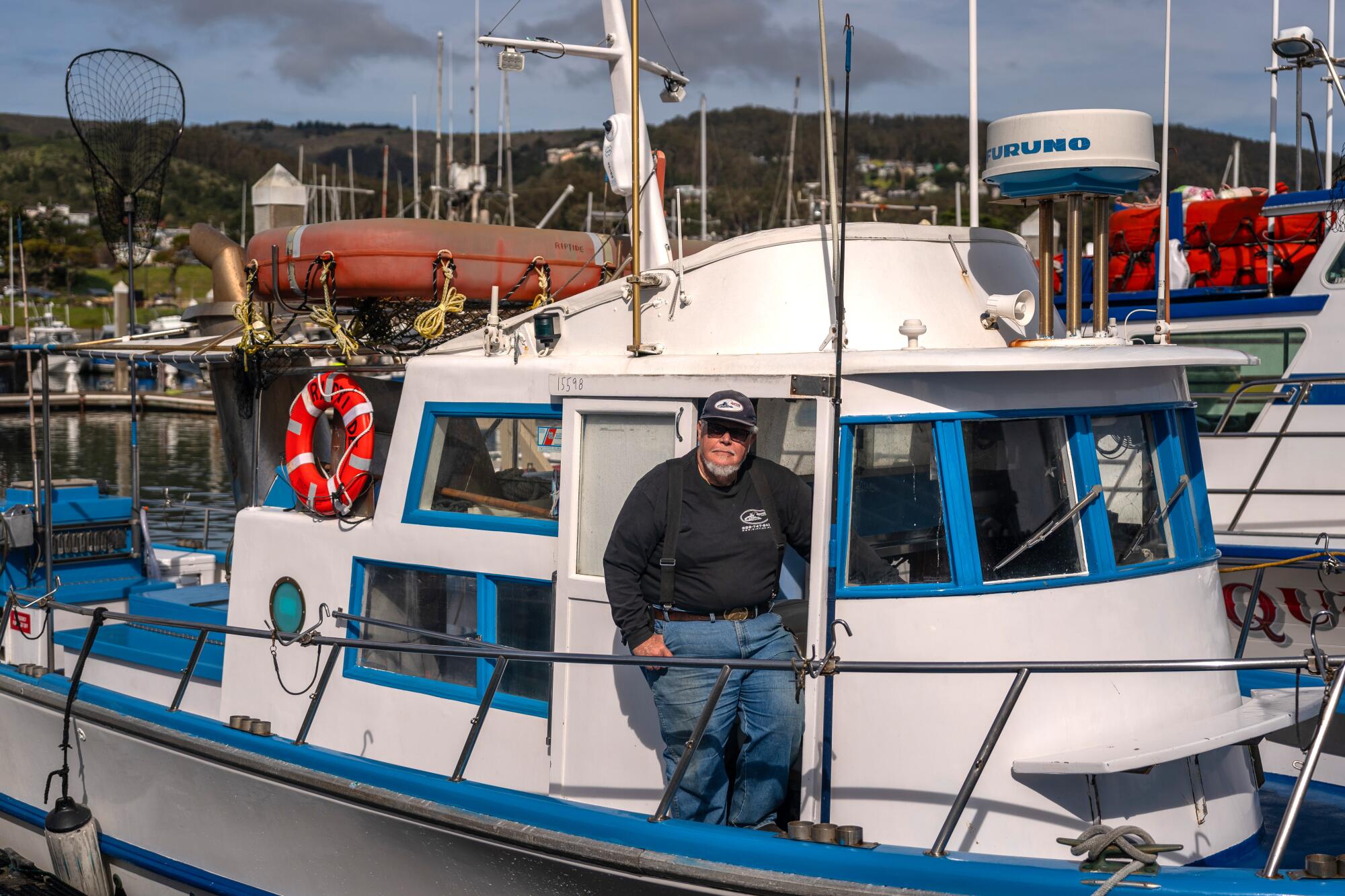 Captain William "Smitty" Smith stands for a portrait at Pillar Point Harbor in Half 