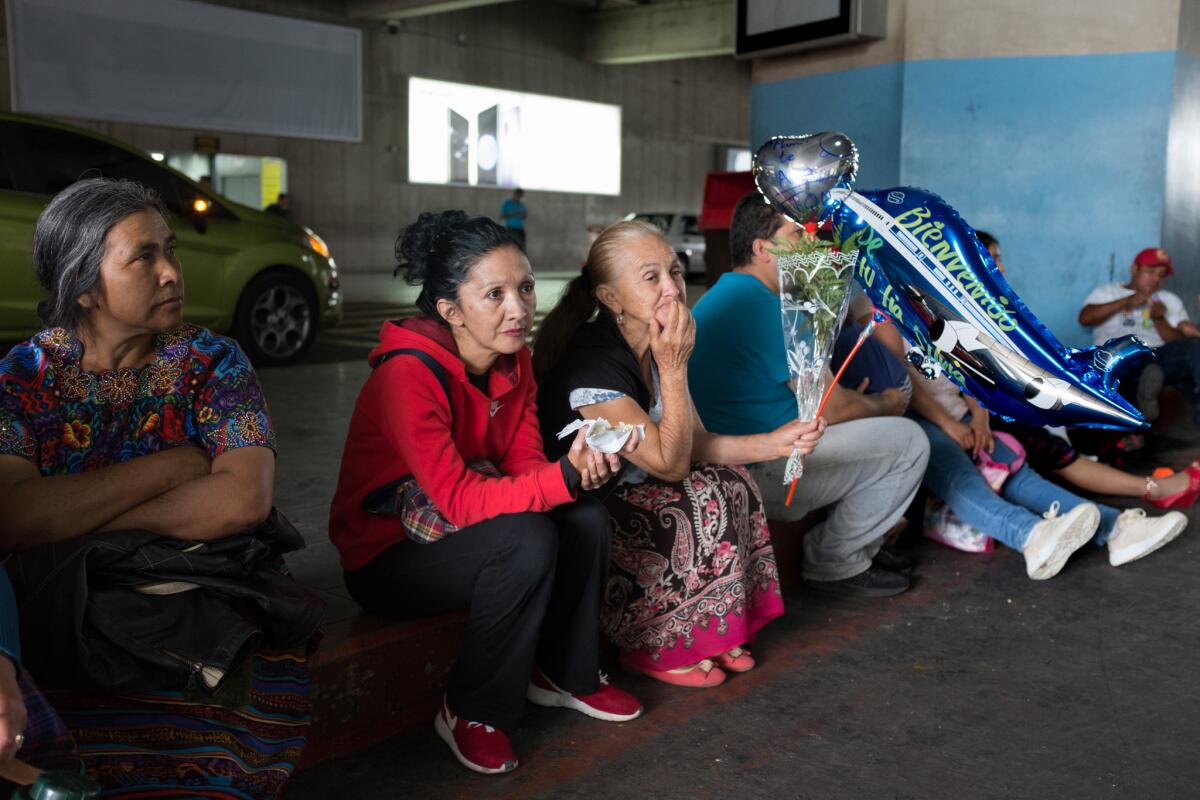 Relatives of 12-year-old Erik Castillo await his arrival at the airport in Guatemala City.