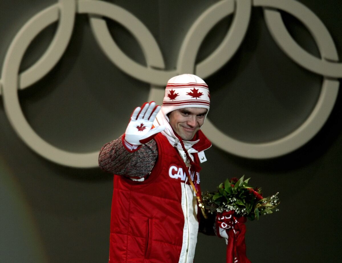FILE - Canada's Duff Gibson celebrates his gold medal during the ceremony for the men's Skeleton competition at the Turin 2006 Winter Olympic Games in Turin, Italy, Feb 18, 2006. Gibson has published a book called “The Tao of Sport” in which he details his mental approach and explains why he thinks that is the difference-maker for elite athletes. (AP Photo/Domenico Stinellis, File)